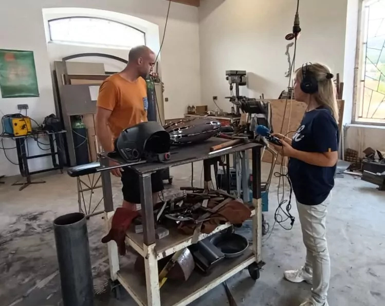 Virginie Saint-Clair réalisant son interview du sculpteur sur métal Félix Valdelièvre dans son atelier de Cases de Pène